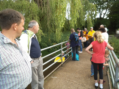 Members viewing the Duck Race from the bridge